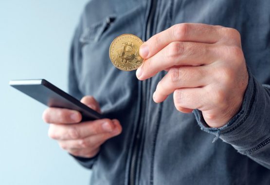 man-with-bitcoin-and-mobile-phone-P8NS7Y4-ozbv10flq08nexxcal2f16k6wov52p9gmyensiokgo